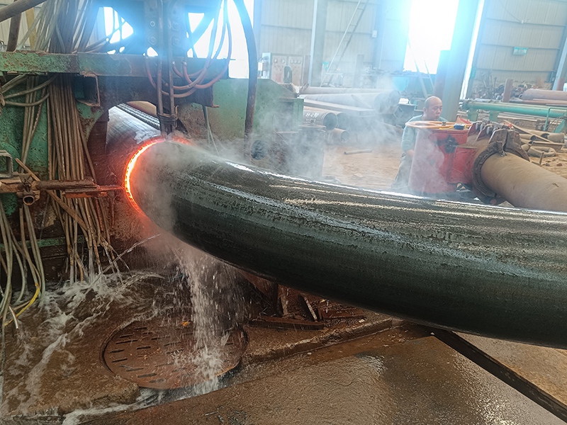 Steel pipe undergoing controlled hot bending